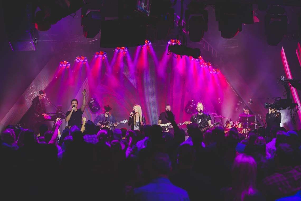 A stage with purple and pink lights